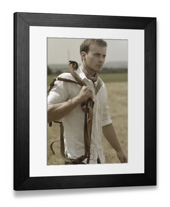 Framed Print : Man wearing riding clothes walking in a field in summer holding a leather strap Framed Print : Man wearing riding clothes walking in a field in summer holding a leather strap