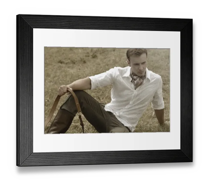 Framed Print : Man wearing riding clothes sitting in a field in summer Framed Print : Man wearing riding clothes sitting in a field in summer