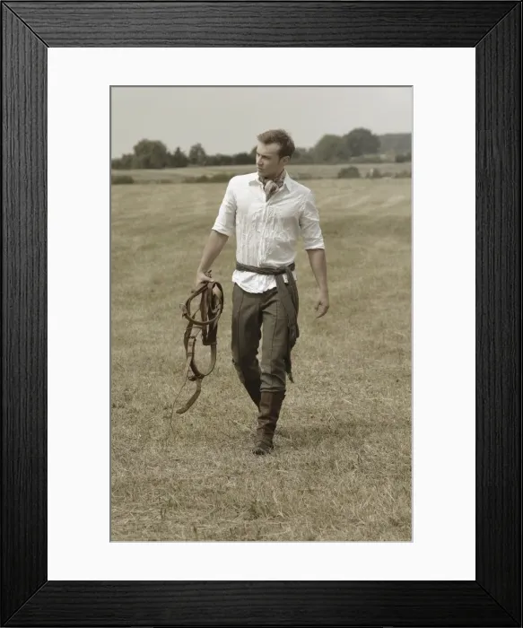 Framed Print : Man wearing riding clothes walking in a field in summer Framed Print : Man wearing riding clothes walking in a field in summer