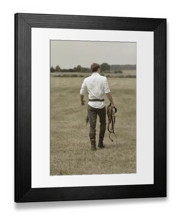 Framed Print : Man wearing riding clothes walking in a field in summer Framed Print : Man wearing riding clothes walking in a field in summer
