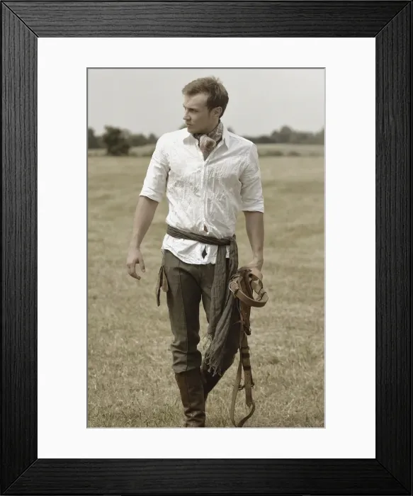 Framed Print : Man wearing riding clothes walking in a field in summer Framed Print : Man wearing riding clothes walking in a field in summer