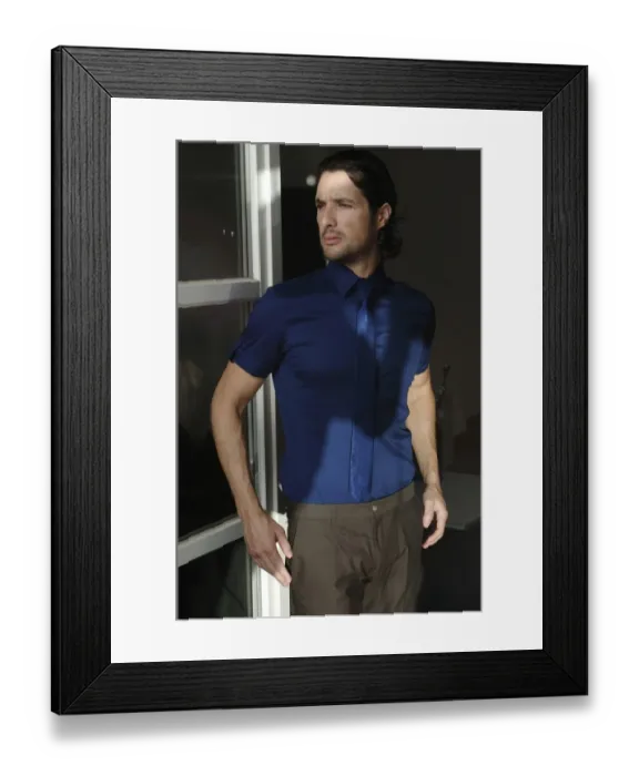 Framed Print : Man standing at a window, fashion shot Framed Print : Man standing at a window, fashion shot
