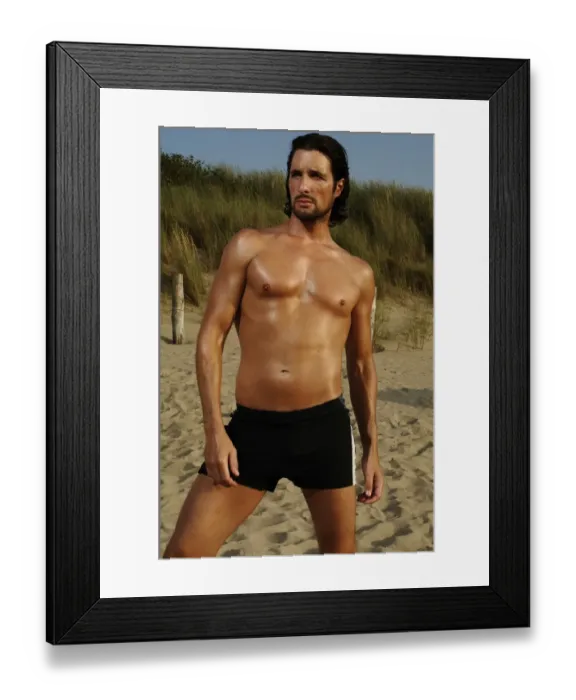 Framed Print : Muscular man wearing swimming trunks posing on beach Framed Print : Muscular man wearing swimming trunks posing on beach
