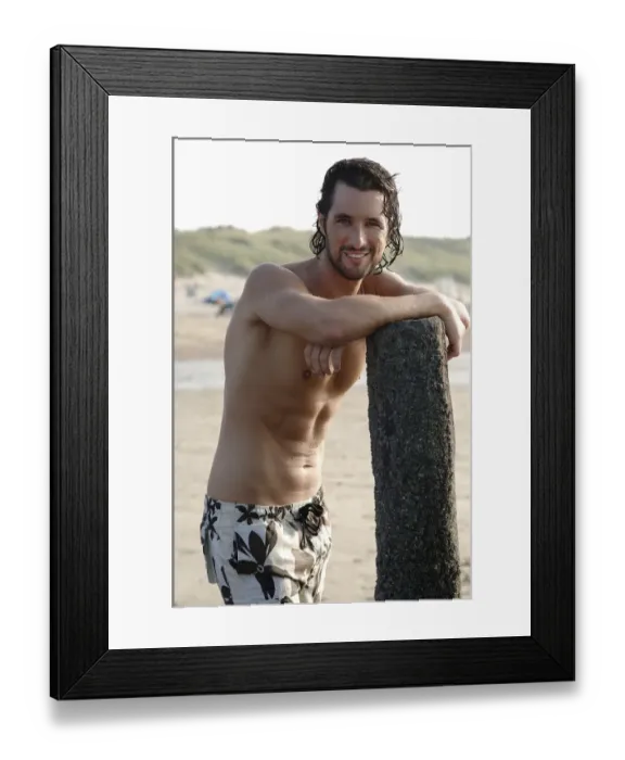 Framed Print : Muscular man wearing swimming trunks standing on a beach Framed Print : Muscular man wearing swimming trunks standing on a beach