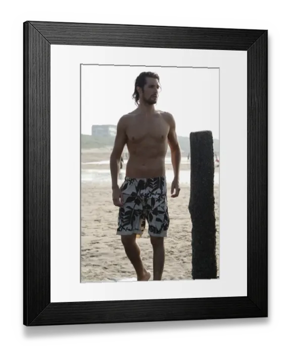 Framed Print : Muscular man wearing swimming trunks standing on a beach Framed Print : Muscular man wearing swimming trunks standing on a beach