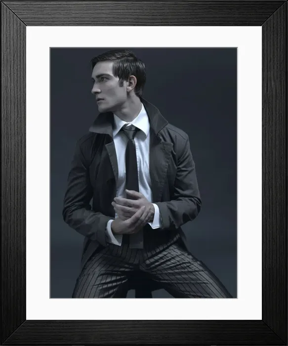 Framed Print : Fashion shot of a man in a suit and jacket, sitting on a stool Framed Print : Fashion shot of a man in a suit and jacket, sitting on a stool