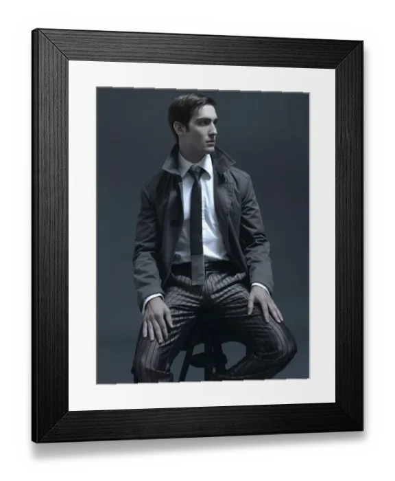 Framed Print : Fashion shot of a man in a suit and jacket, sitting on a stool Framed Print : Fashion shot of a man in a suit and jacket, sitting on a stool