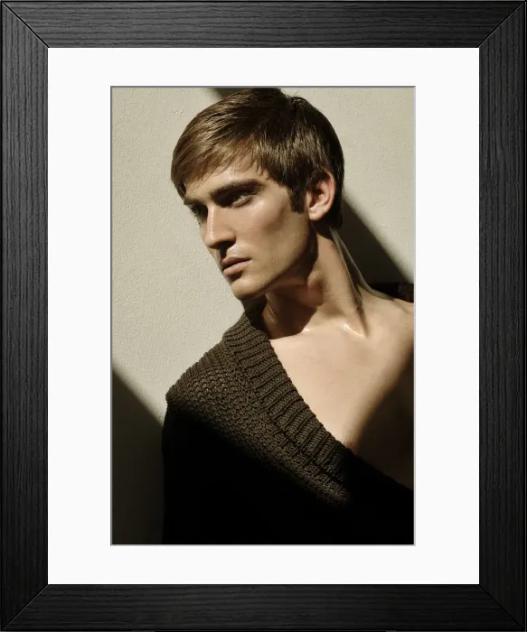Framed Print : Portrait of a young man leaning on a wall in the sunlight Framed Print : Portrait of a young man leaning on a wall in the sunlight