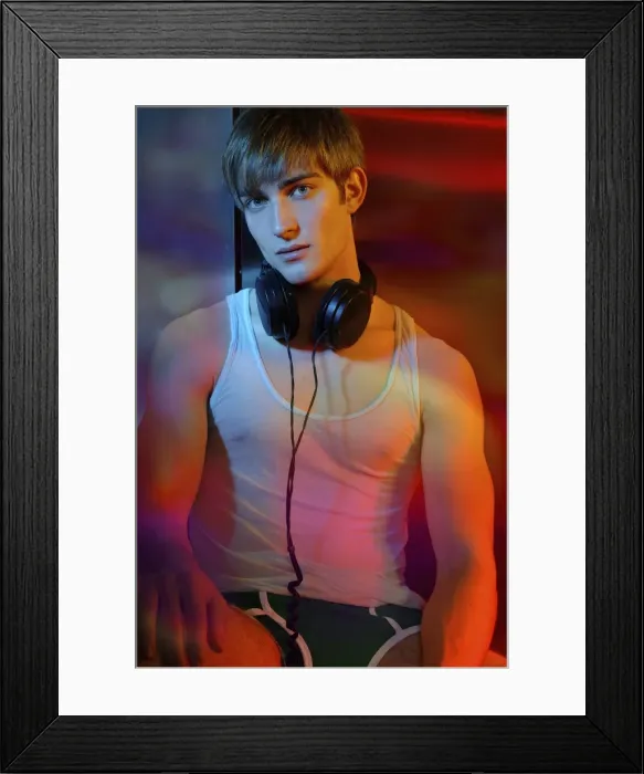 Framed Print : Young man in underwear with headphones in colorful light Framed Print : Young man in underwear with headphones in colorful light