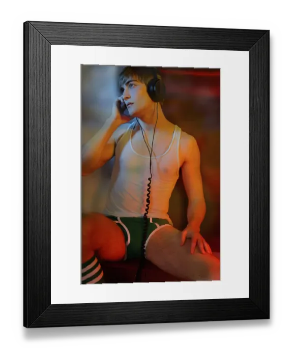 Framed Print : Young man in underwear with headphones in colorful light Framed Print : Young man in underwear with headphones in colorful light