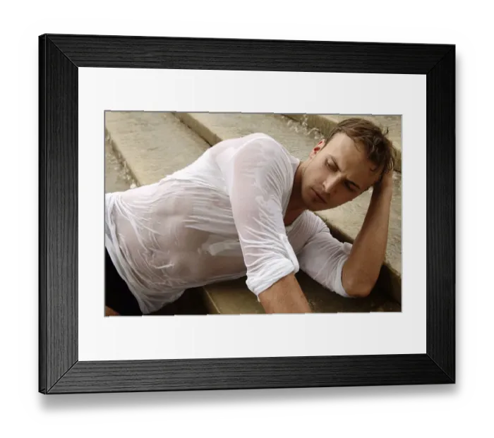 Framed Print : Young man wearing a wet shirt, lying on stairs Framed Print : Young man wearing a wet shirt, lying on stairs