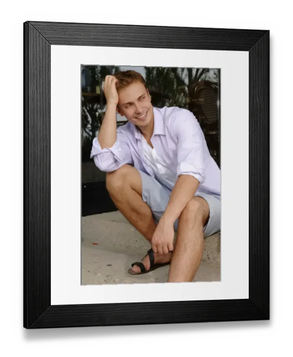Framed Print : Young man wearing shorts, sitting Framed Print : Young man wearing shorts, sitting