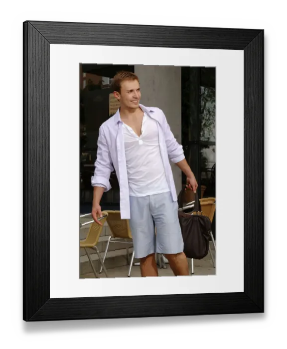 Framed Print : Young man with a bag wearing shorts, shopping spree Framed Print : Young man with a bag wearing shorts, shopping spree