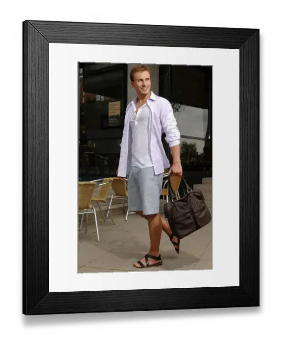 Framed Print : Young man with a bag wearing shorts and sandals, shopping spree Framed Print : Young man with a bag wearing shorts and sandals, shopping spree