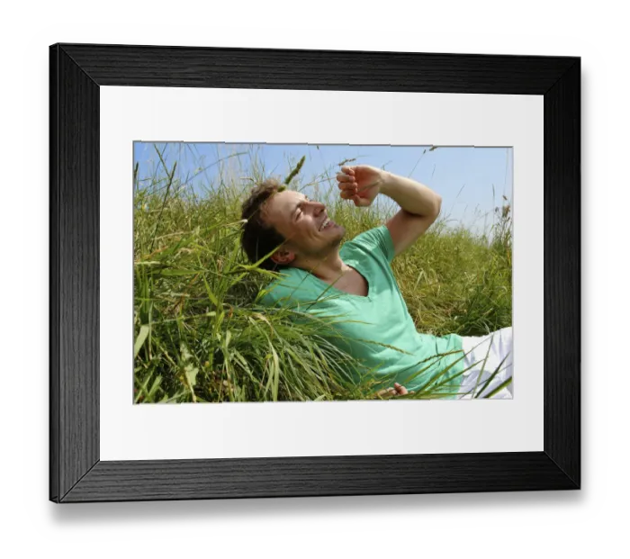 Framed Print : Young man lying in tall grass, smiling, sunbathing Framed Print : Young man lying in tall grass, smiling, sunbathing