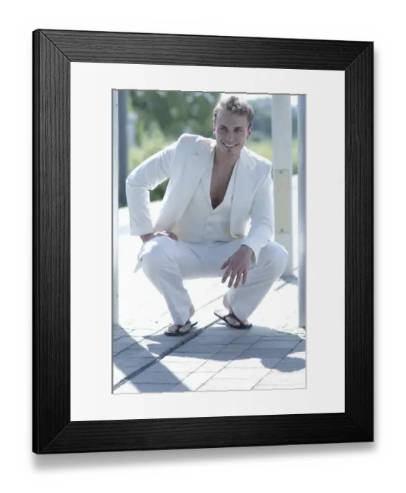 Framed Print : Young man wearing a white suit, smiling Framed Print : Young man wearing a white suit, smiling