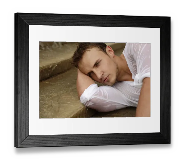 Framed Print : Young man wearing a wet shirt, lying on stairs Framed Print : Young man wearing a wet shirt, lying on stairs