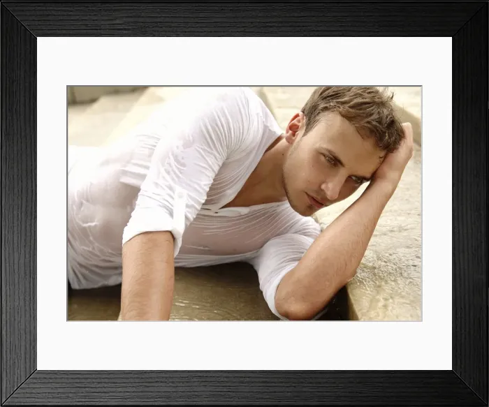 Framed Print : Young man wearing a wet shirt, lying on stairs Framed Print : Young man wearing a wet shirt, lying on stairs