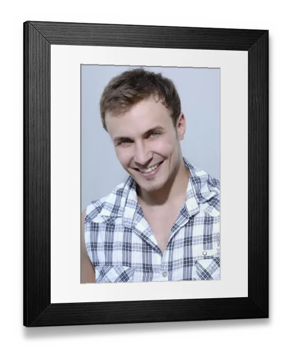 Framed Print : Young man smiling, wearing a check shirt, portrait Framed Print : Young man smiling, wearing a check shirt, portrait