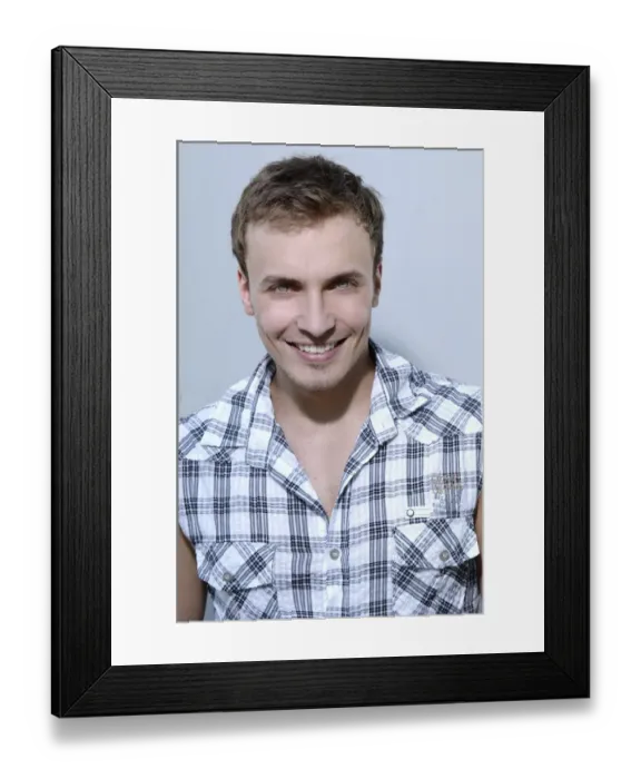 Framed Print : Young man smiling, wearing a check shirt, portrait