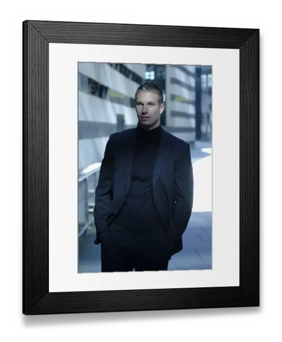 Framed Print : Business man wearing a dark suit in front of a bank building Framed Print : Business man wearing a dark suit in front of a bank building