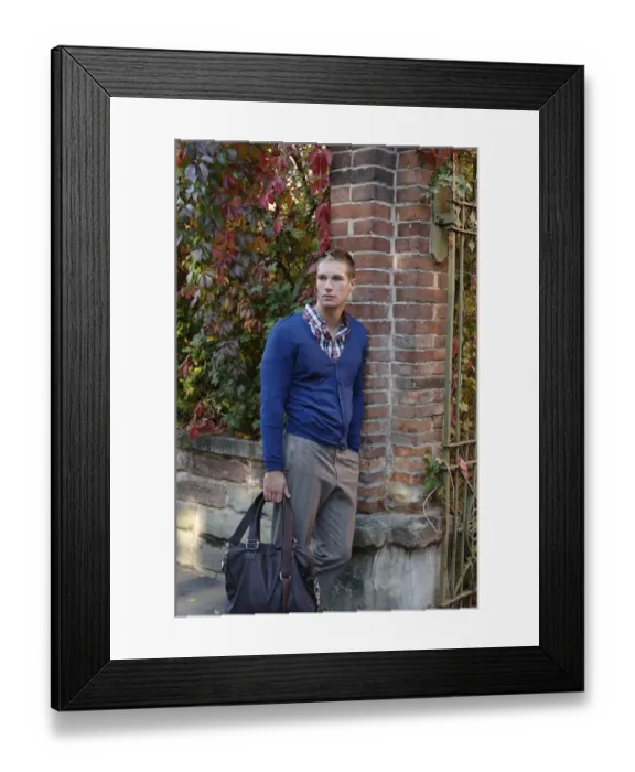 Framed Print : Young man waiting at a gate with a bag