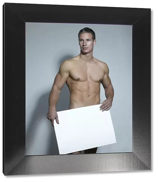 Naked man holding a blank sign in his hands