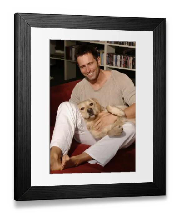 Framed Print : Man with Golden Retriever sitting on a sofa Framed Print : Man with Golden Retriever sitting on a sofa