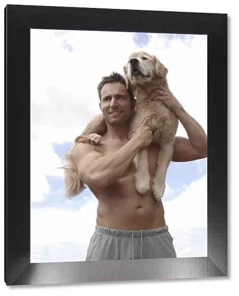 Man with Golden Retriever on his shoulder