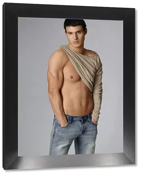 Young athlete in jeans, with half-naked chest
