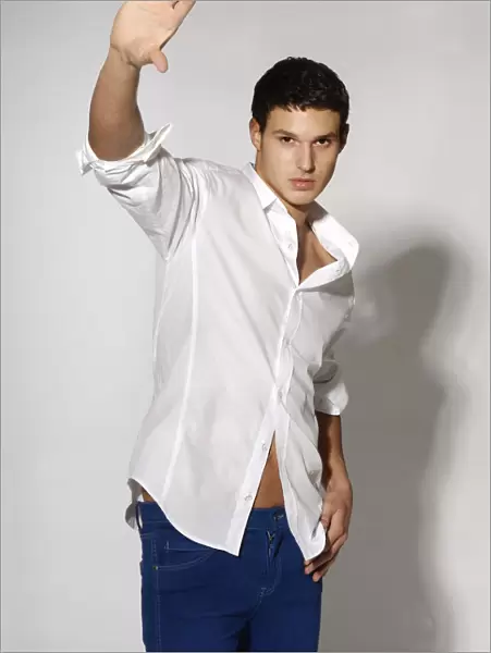 Young man in white shirt and blue jeans in movement