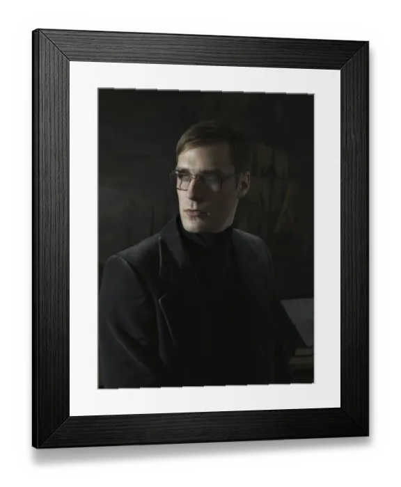 Framed Print : Student wearing a suit and glasses, sitting in front of a painting Framed Print : Student wearing a suit and glasses, sitting in front of a painting
