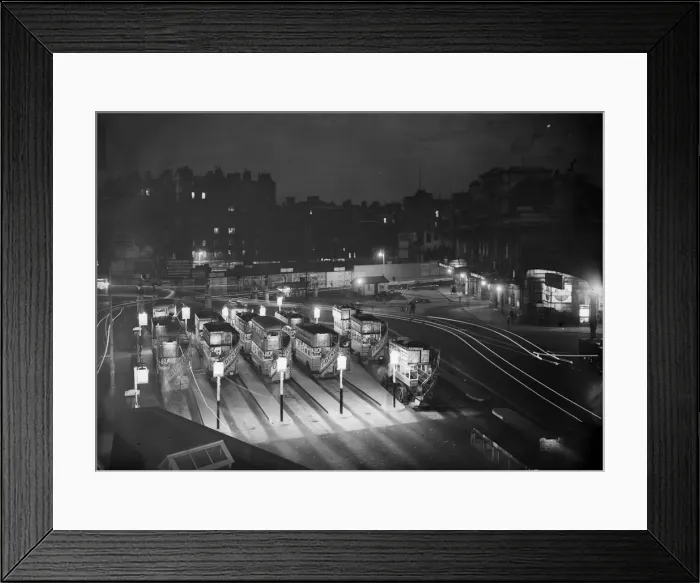 Framed Print : Bus Park. circa 1925: Double decker buses parked in line for the night