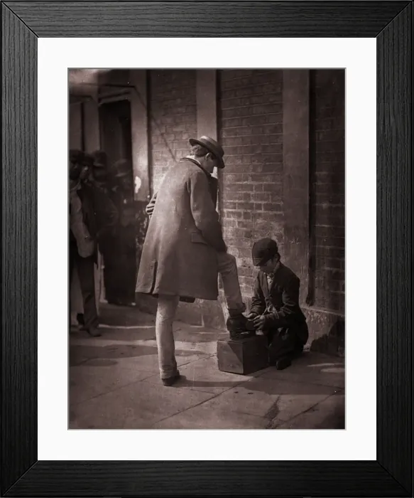 Framed Print : Shoeshine. 1877: A young independent shoeblack shines the boots of a city gent Framed Print : Shoeshine. 1877: A young independent shoeblack shines the boots of a city gent