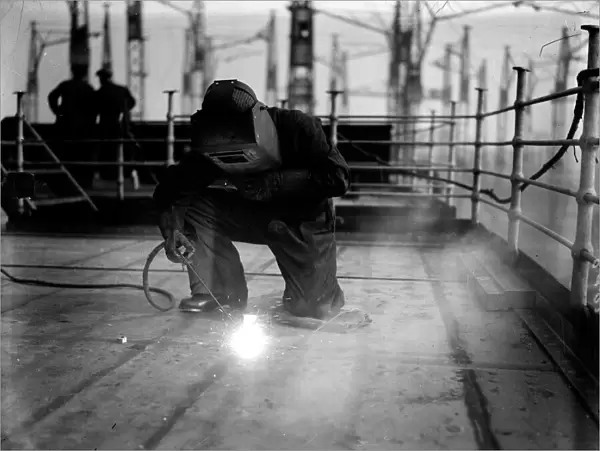 Welding. A welder at work on the construction of the liner Queen Mary at Clydebank