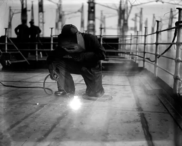 Welding. A welder at work on the construction of the liner Queen Mary at Clydebank