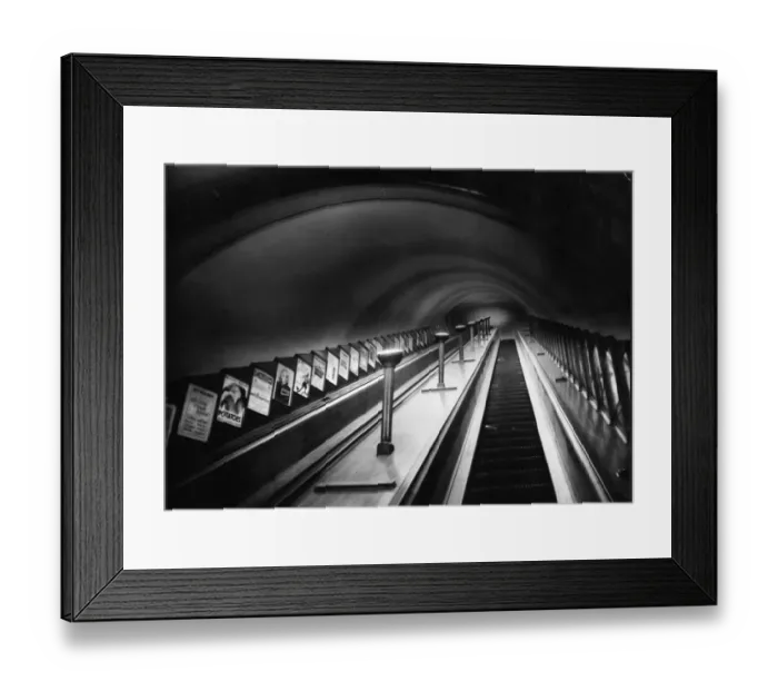 Framed Print : Escalator. circa 1930: An escalator on London Underground with posters on show at the side