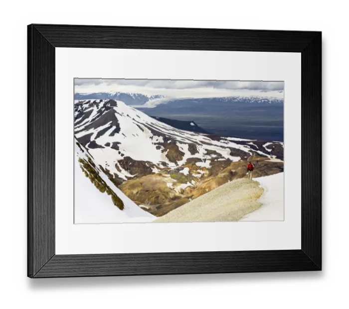 Framed Print : Rear view of man hiking down a mountain Framed Print : Rear view of man hiking down a mountain
