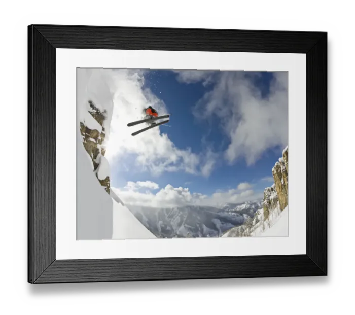 Framed Print : Freestyle skier spinning while jumping off of cliff