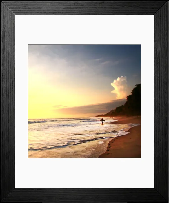 Framed Print : Surfer stands in ocean watching sunset on beach Framed Print : Surfer stands in ocean watching sunset on beach