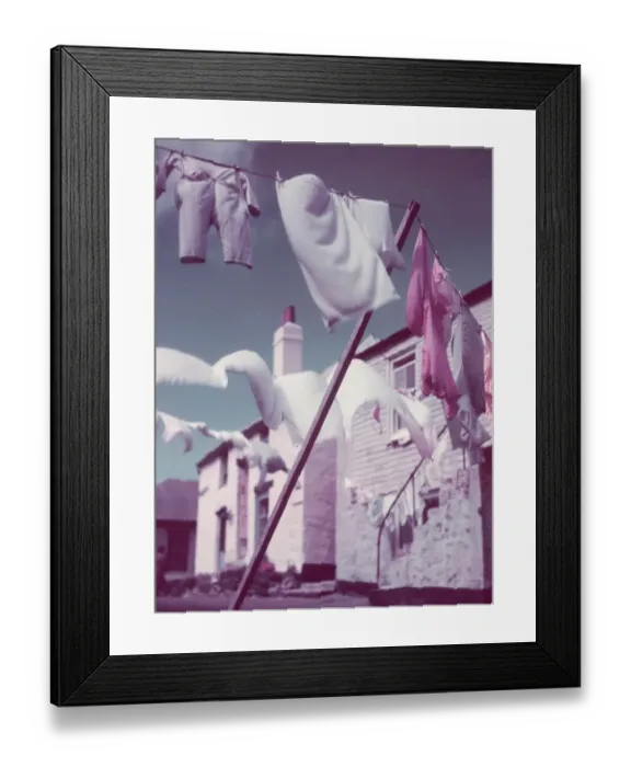 Framed Print : Blustery. Washing lines strung across a village street Framed Print : Blustery. Washing lines strung across a village street