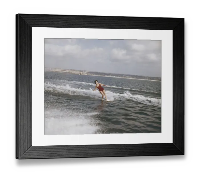 Framed Print : Woman surfing on sea