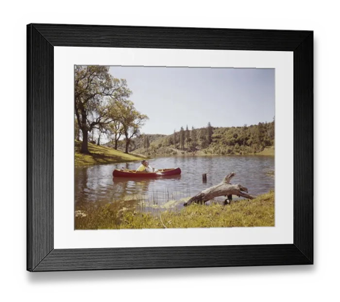 Framed Print : Couple fishing from canoe in lake Framed Print : Couple fishing from canoe in lake