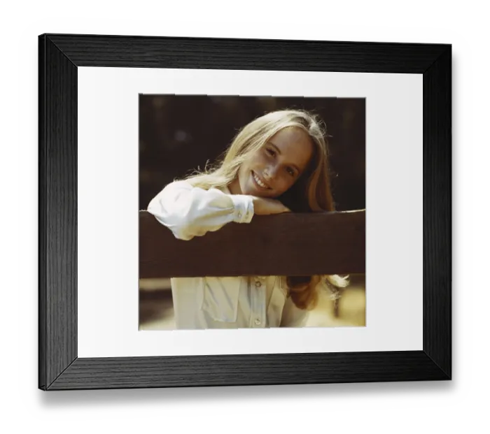 Framed Print : Young woman leaning on fence, smiling, portrait, close-up Framed Print : Young woman leaning on fence, smiling, portrait, close-up