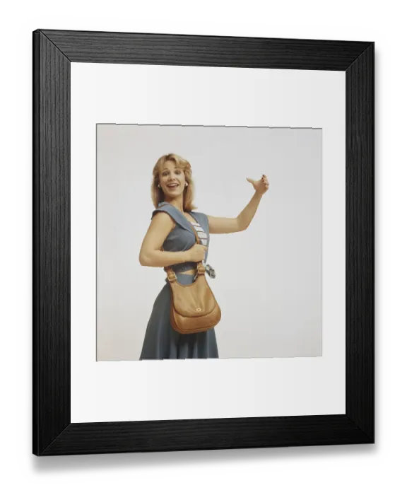 Framed Print : Woman standing with handbag and gesturing, close-up Framed Print : Woman standing with handbag and gesturing, close-up