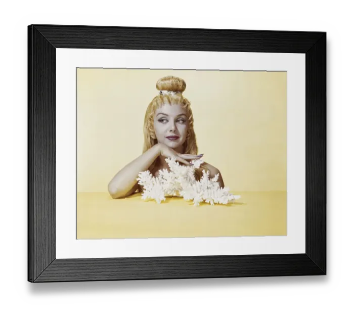 Framed Print : Woman with hairstyle and make-up against yellow background Framed Print : Woman with hairstyle and make-up against yellow background