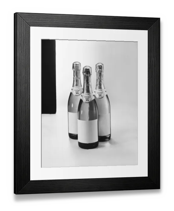 Framed Print : Champagne bottles against white background, close-up Framed Print : Champagne bottles against white background, close-up