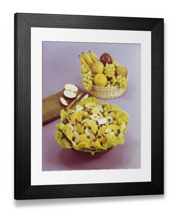 Framed Print : Fruit salad and basket against pink background, , close-up Framed Print : Fruit salad and basket against pink background, , close-up