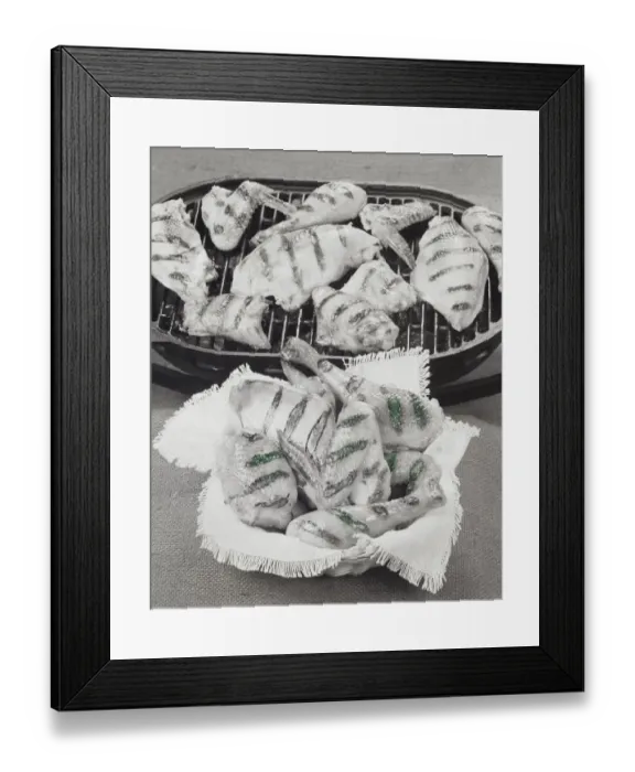 Framed Print : Meats on barbecue grill and basket of meat in foreground, close-up