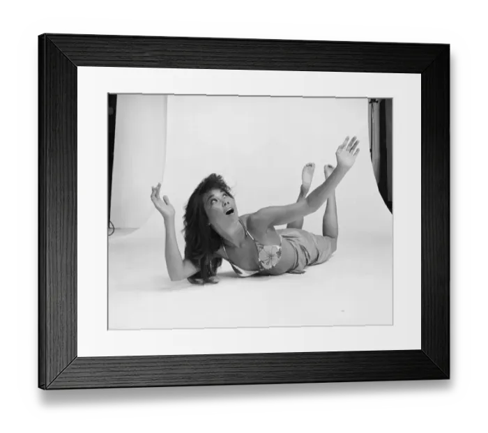 Framed Print : Young woman lying on white background, looking up Framed Print : Young woman lying on white background, looking up